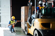 © NewSaetiew - Warehouse worker workers with forklift in a warehouse. Use forklift operator moves packages. Concept industrial and commercial.