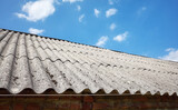 Fototapeta  - Picture of a roof made of carcinogenic asbestos tiles, selective focus.