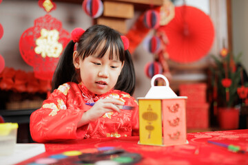 Wall Mural - young girl with traditional dressing up celebrating Chinese new year against all kind of 