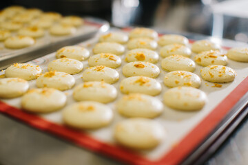 Wall Mural - Freshly baked macaroons on a baking sheet.