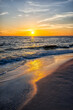 Colorful vertical sunset seascape and sun horizon in Gulf of Mexico sea ocean coast with water waves in Seaside Santa Rosa Beach, Florida panhandle and reflection of path