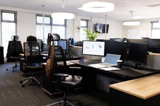 Empty open space office with desks, chairs and computers