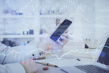 Poster - Double exposure of man's hands holding and using a digital device and forex graph drawing. Financial market concept.