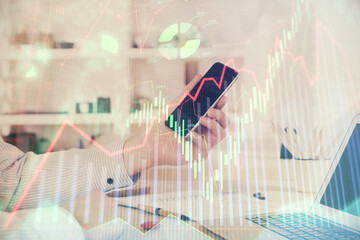 Aufkleber - Double exposure of man's hands holding and using a digital device and forex graph drawing. Financial market concept.