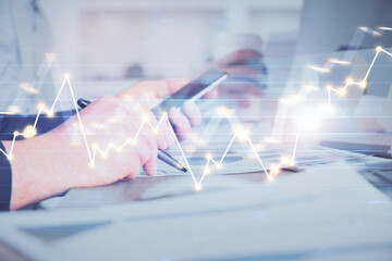Poster - Double exposure of man's hands holding and using a phone and financial chart drawing. Market analysis concept.