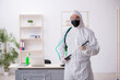 © Elnur - Young male contractor disinfecting office during pandemic