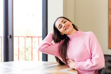 pretty caucasian woman smiling cheerfully and casually, taking hand to head with a positive, happy and confident look