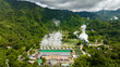 Aerial view of geotermal power plant in the mountains. Geothermal station with steam and pipes. Negros, Philippines.