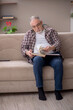 © Elnur - Old man reading book at home