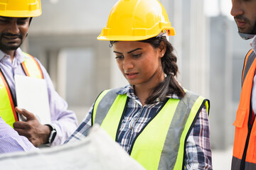 Wall Mural - India engineer woman holding paper work with team engineer man at precast site work	