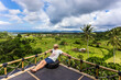 © Cavan Images - Clouds over young man relaxing alone on tree house balcony, Bali, Indonesia