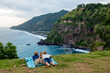 © Cavan Images - Adult couple lying together on blanket and admiring ocean coastline, Bali, Indonesia