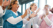 © Nina Lawrenson/peopleimages.com - Doctor, support and applause in celebration for team unity, healthcare achievement or goal at the hospital. Group of medical professional clapping and celebrating teamwork, unity or victory at clinic