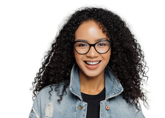 Wall Mural - Glad woman with curly hair, wears optical glasses, denim jacket, looks straightly at camera, isolated on grey background, enjoys lovely conversation, satisfied with finished work. Facial expressions