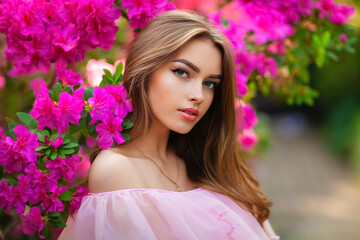 close up portrait of beautiful girl in pink vintage dress and straw hat standing in garden near colo