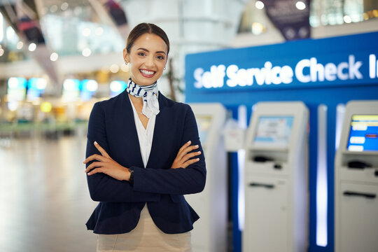 woman, passenger assistant and arms crossed at airport by self service check in station for informat