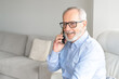 © Danko - Smiling older man talking on cellphone close up, happy grandfather chatting with relatives or grandchildren, satisfied mature male making or answering phone call, having pleasant conversation