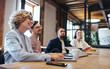 © Jacob Lund - Conference meeting in an office, happy business team sits together in a boardroom