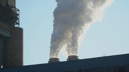 Wall Mural - The chimney of a thermal power plant, the smoke extracted by a thermal power plant on the chimney, in the production process. Environment. Pollution.