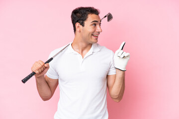 Wall Mural - Young golfer player man isolated on pink background intending to realizes the solution while lifting a finger up