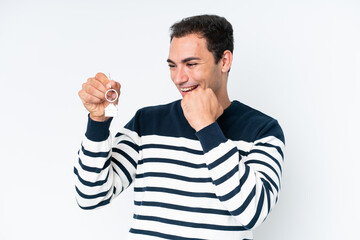 Wall Mural - Young caucasian man holding home keys isolated on white background celebrating a victory