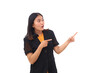 © ArvStd - Amazed young asian business woman standing while pointing at blank space beside her. Isolated