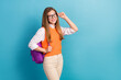 © deagreez - Portrait of positive clever girl hand touch eyewear empty space promotion isolated on blue color background