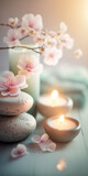 Fototapeta Boho - Concept Feng Shui. Zen spa relaxation. Ambiance salon de beauté et de massage. Bannière avec fleurs de cerisier sakura, bougies et pierres empilées. Atmosphère calme et reposante. Generative AI
