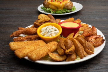 Wall Mural - Combo plate of Cheese balls, Mozzarella cheese, Wedges, Garlic Bread, Chicken Tenders with sauce