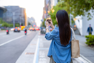 Canvas Print - Woman take photo on the street in Taipei city