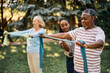 © Drazen - Black senior man practicing with power band on exercise class at residential care home.