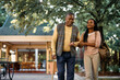 © Drazen - Happy black woman walks with her senior father while visiting him at nursing home.