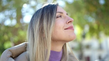 Poster - Young blonde woman smiling confident breathing at park