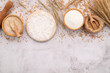 The ingredients for homemade pizza dough with wheat ears ,wheat flour and wheat grains set up on white concrete background.
