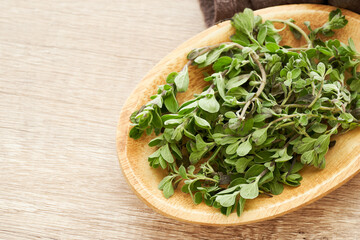 Wall Mural - sweet marjoram leaves in wood bowl on wooden table background. fresh sweet marjoram leaves background. sweet marjoram leaves                                                    