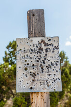 Simpson Return Trail, Road Side Sign With Bullet Holes.