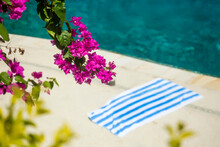 Flowers And Blanket On Edge Of Swimming Pool