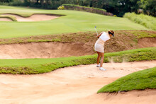 Female Golf Player In Sand Trap, Bali, Indonesia