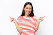 © luismolinero - Young Colombian woman isolated on white background pointing finger to the laterals and happy