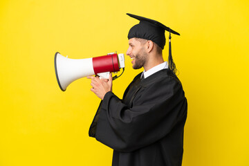 Wall Mural - Young university graduate caucasian man isolated on yellow background shouting through a megaphone