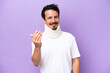 © luismolinero - Young caucasian man wearing neck brace isolated on purple background inviting to come with hand. Happy that you came