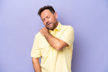 Wall Mural - Middle age caucasian man isolated on purple background suffering from pain in shoulder for having made an effort