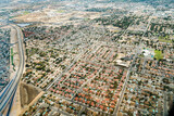 Fototapeta Miasta - Aerial view of a geometric residential area with bungalows. Each house has a pool. This suburban housing complex is in a geometrical form.