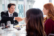 © NT_studio - Happy team young business people in party celebrate success talking and introduce friends together with enjoyment at restaurant, friendly and social colleague, meet friend and community concept.