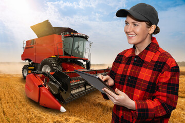 Autocollant - Woman farmer with digital tablet on a background of harvester. Smart farming concept.