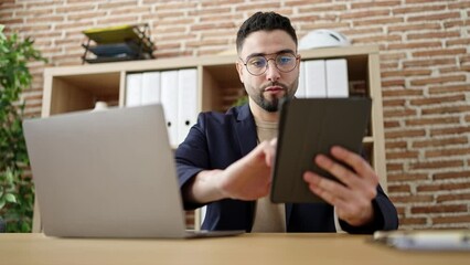 Sticker - Young arab man business worker using touchpad and laptop at office