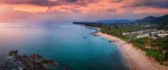 Wall Mural - panoramic sunset view of the beautiful coast of khao lak, thailand, with turquoise sea next to fine 