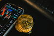 Golden coins with bitcoin symbol and crypto graph