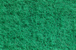 Fleecy fibrous synthetic green surface sponge close-up macro background wallpaper, uniform texture pattern