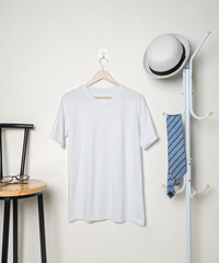 Wall Mural - A minimalist v-neck shirt mockup that presents a garment adorned with subtle decoration, hung in a way that enhances its refined and elegant aesthetic